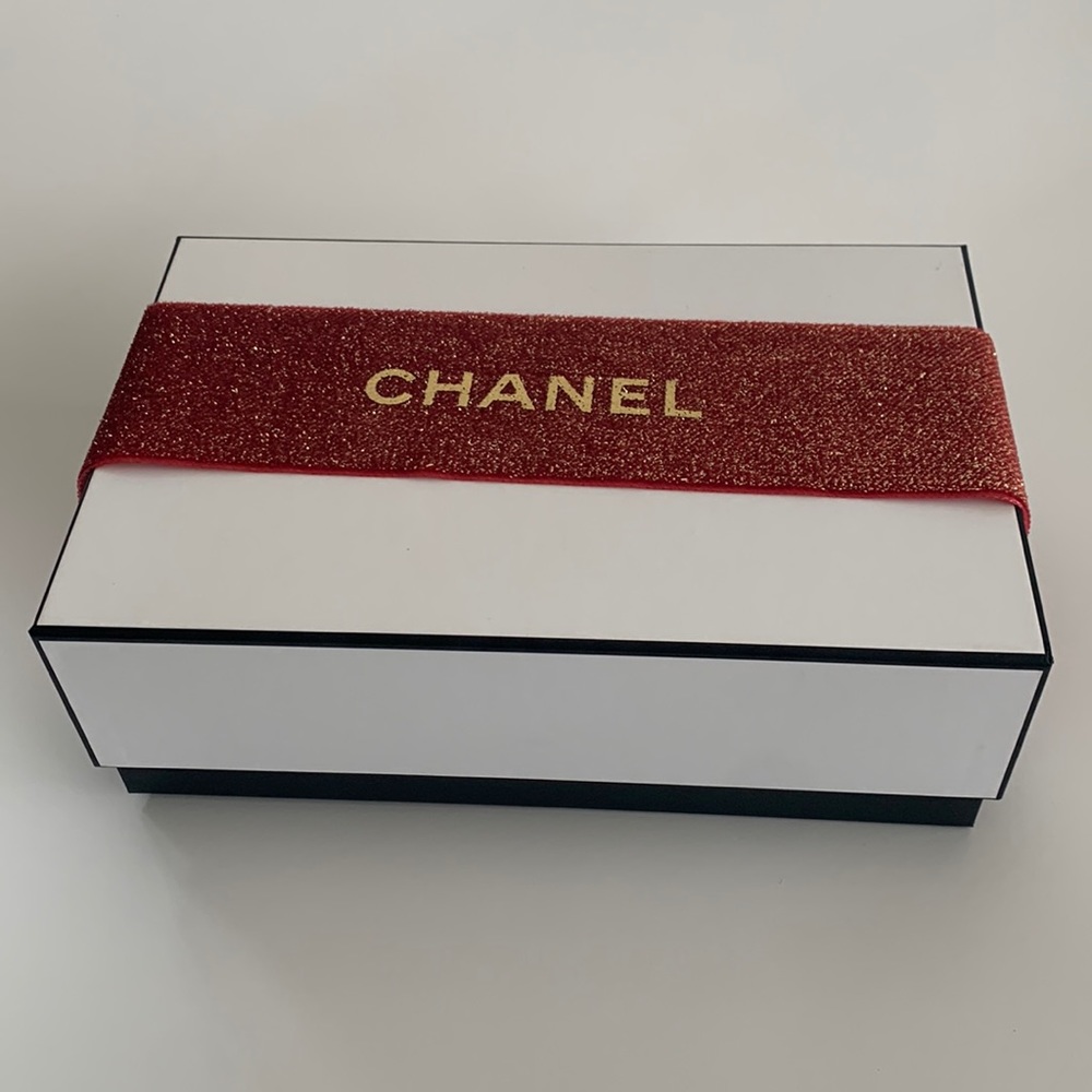 Chanel gift box with red Chanel wrap around ribbon and a logo card